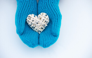 Female hands in mittens with heart, close up