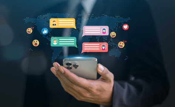 Human hand using smartphone typing Live chat chatting and social network concepts, chatting conversation working at home in chat box icons pop up. Social media marketing technology concept