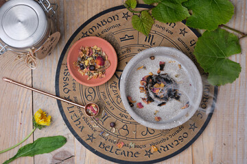 Beltane Incense Ritual with Resins, Herbs and Smoke on Wooden Table