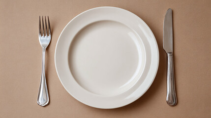 Elegant table setting with empty plate, fork, and knife on neutral background. Perfect for showcasing culinary artistry or minimalist design.