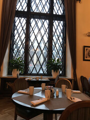 Morning in a Classic Café – Calm Light Through Lattice Windows
