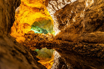 Cueva de los Verdes – Illuminated volcanic lava tube on the Canary Island of Lanzarote with a perfect reflection in a natural lagoon