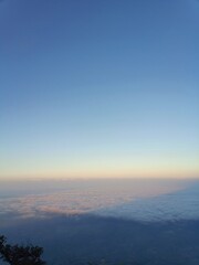 Mountain Shadow Cast Over Clouds During Sunrise
