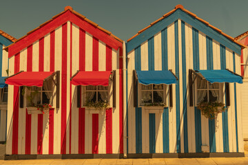 Costa Nova, Portugal: colorful striped houses called Palheiros with red, blue and red stripes. Costa Nova do Prado is a beach village resort on Atlantic coast near Aveiro, Portugal - Travel concept