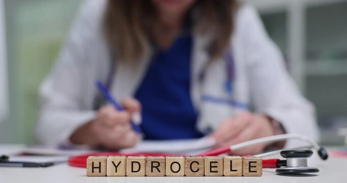 Word Hydrocele put on wooden cubes placed near doctor documents and stethoscope. Medical term appears among tools suggesting clinical diagnosis