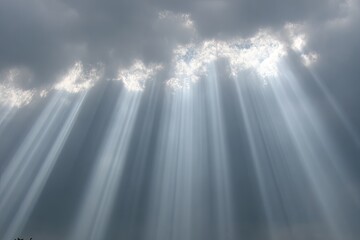 Sunlight beams piercing through dark clouds