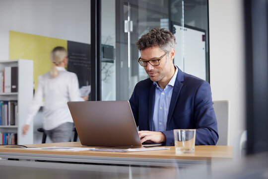 Businessman working on laptop in office
