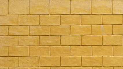Full frame shot of an new textured wall with rectangular blocks. Showing weathering and discoloration. Great as a background for vintage rustic or architectural designs.