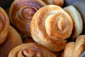 Freshly baked appetizing cinnamon and sugar rolls in close-up