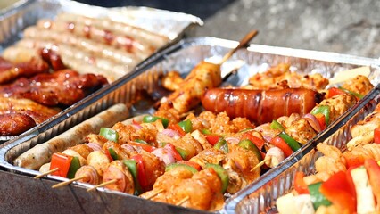 Grilled meat selection on a foil tray, ready for a barbecue or outdoor feast