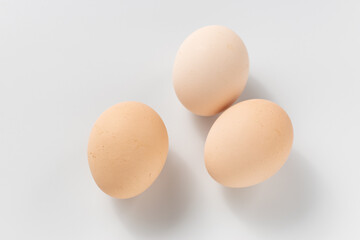 Raw hen's eggs. Light-colored chicken eggs on a white background. Healthy natural foods
