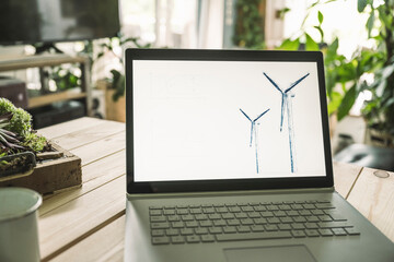 Wind turbine design on screen of laptop at home office