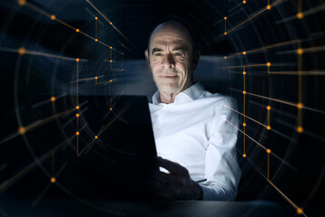 Businessman using laptop amidst illuminated dots at office