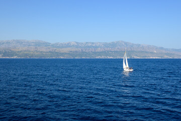 Fototapeta premium A yacht in the Adriatic Sea, with the Croatian coast in the background