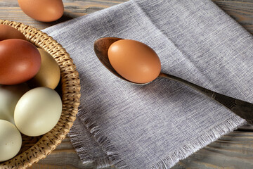 Beautifully colorful ecologically clean chicken eggs on wooden surface