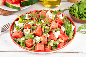 Watermelon salad with feta, arugula, nuts, pumpkin seeds