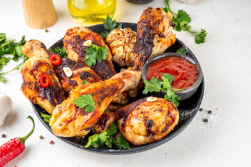Grilled chicken legs with garlic, spices, parsley, bbq sauce and olive oil