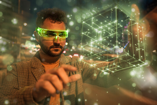 Engineer touching and examining cube shaped blockchain data through smart glasses