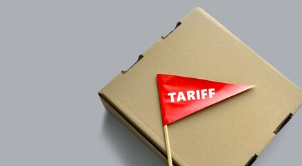 Red flag on package. Warning sign 'Tariff'. Cardboard box. Sustainable packaging, transportation, business, tariffs concept