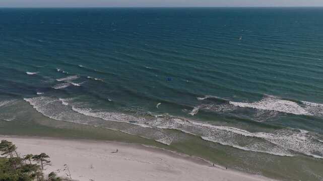 waves on the beach kitesurfers surfing