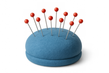 Blue pincushion securing multiple sewing pins with vibrant red heads, supporting precise textile crafting on transparent backdrop