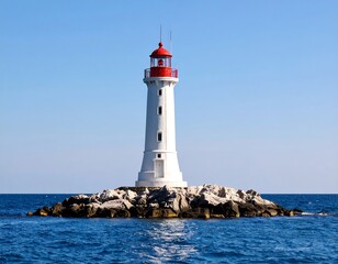 A lighthouse stands tall on a rocky outcrop in the sea