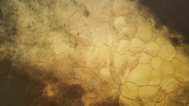 Aerial view of parched earth reveals a tapestry of cracks and fissures, painted in earthy tones under the sun, Pikrolimni, Kilkis, Greece.