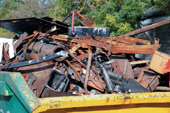 Scrap metal iron, steel and aluminium in a skip container waiting to be recycled or landfill, environmental waste disposal stock photo image