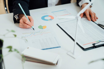 Businesswoman planning strategy with documents at desk