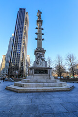 Christopher Columbus Monument at Columbus circle against skyscraper and clear blue sky