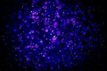 Blurred photo with purple violet and blue dots visible glittering, shining brightly look and feel luxurious