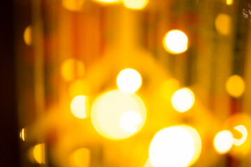 close-up blurred photo Golden decorative lights create a luxurious atmosphere at night events....