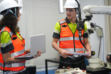 Fototapeta premium Smart Latino engineer working on AI technology in robotics electronics engineering laboratory. Hispanic students' research project is programming robot machine with intelligent mechanical control