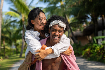 Carefree couple enjoying a tropical beach vacation, laughing making unforgettable memories together