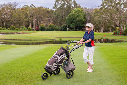 senior woman with golf caddy