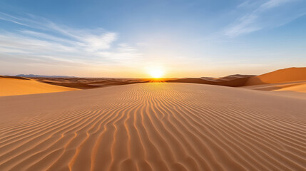 Golden desert dunes glowing under warm sunset light create serene landscape