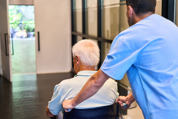 Fototapeta premium Nurse assisting an elderly person in a senior care rehabilitation facility