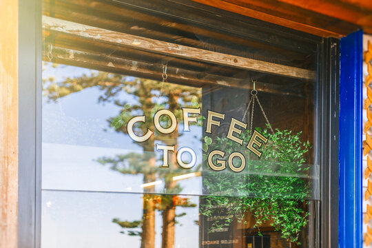 Coffee shop window with reflection of trees