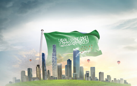 Saudi Arabia national flag wavering with modern building skyline. Country showing stronger and prosperity. Flag key visual. Saudi Arabian national flag for independence day.
