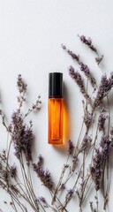 Orange roller bottle stands on white paper, framed by dried lavender sprigs. Black cap tops the bottle, contrasting with the warm-toned liquid inside and muted purple flowers