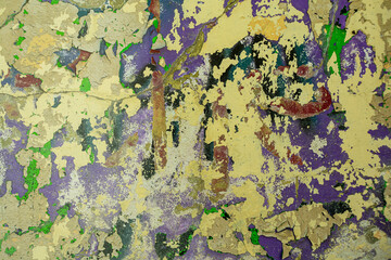 Abstract: crumbling graffiti on a city street wall. Colorful abstract background. Old, cracked,...
