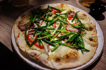 Delicious freshly prepared gourmet asparagus pizza topped with vibrant vegetables and savory ingredients