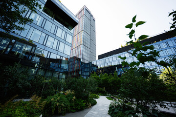 Modern urban architecture surrounded by lush greenery in city environment