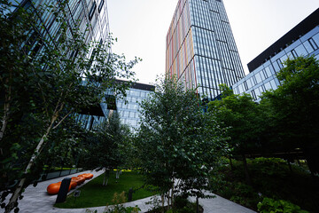 Modern urban building surrounded by lush greenery and vibrant urban designs