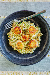 pan seared sea scallops on a bed of sautéed corn, topped with chives