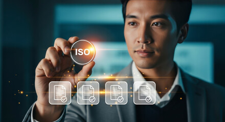 Man holding a glowing ISO standard icon above digital document icons, representing quality management and certification processes
