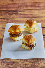 slider trio consisting of a cheeseburger, turkey melt, and corned beef sandwich