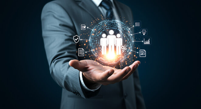 Businessman holding a glowing digital network sphere with team members and business icons symbolizing global connectivity and collaboration