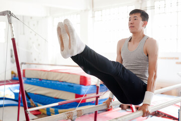 Athlete training on parallel bars in gymnastics gym