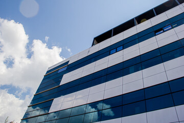 Modern office building with blue sky and white clouds. Business background. natural background
